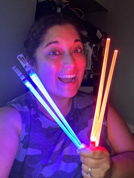 The reviewer holding the set of chopsticks