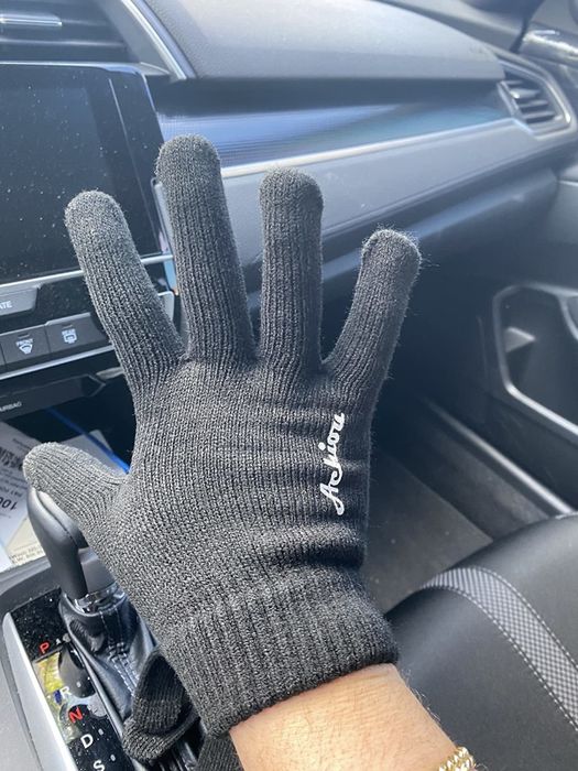 Reviewer modeling black gloves featuring a knitted design