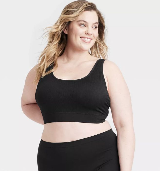 A model wearing a sleek black comfort bralette