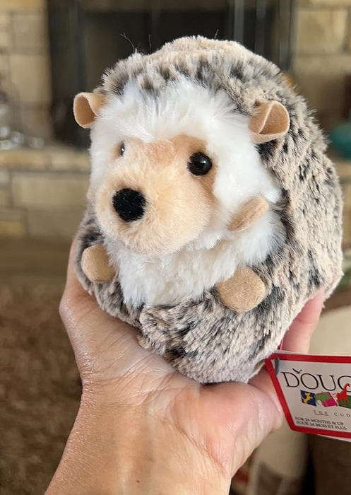 The reviewer holding the plushie close up