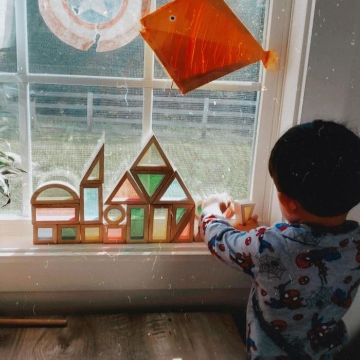 A photograph taken by a reviewer showcasing blocks against a window, with a child happily playing with them.