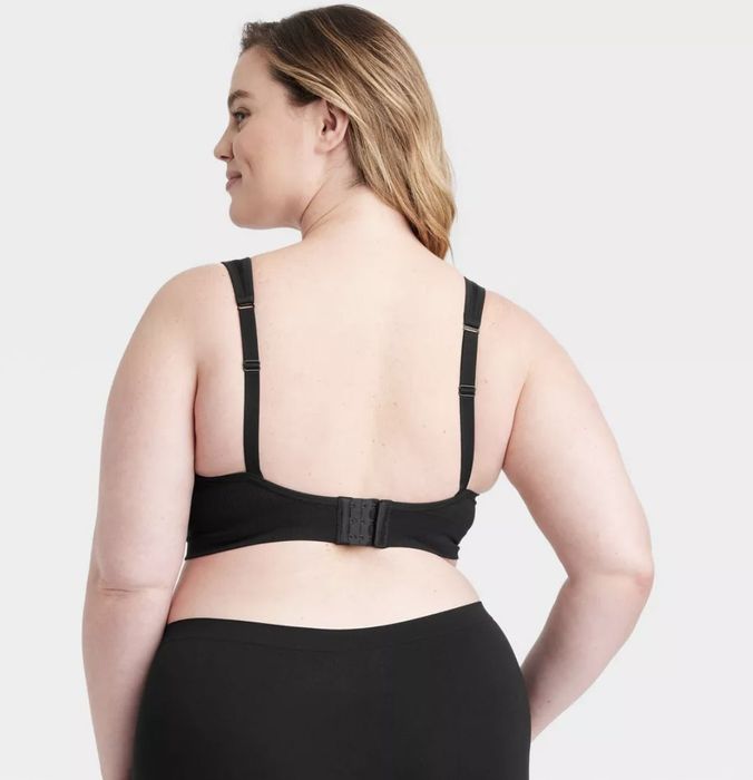 A model wearing a black comfort bralette, viewed from the back