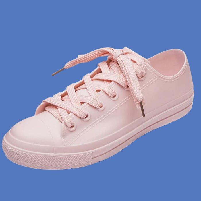 A minimalist sneaker design, featuring laces and a rubber sole, displayed against a simple background.