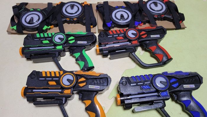 A set of toy laser guns with colorful targets, each featuring unique designs. Great for interactive play and engaging gaming sessions