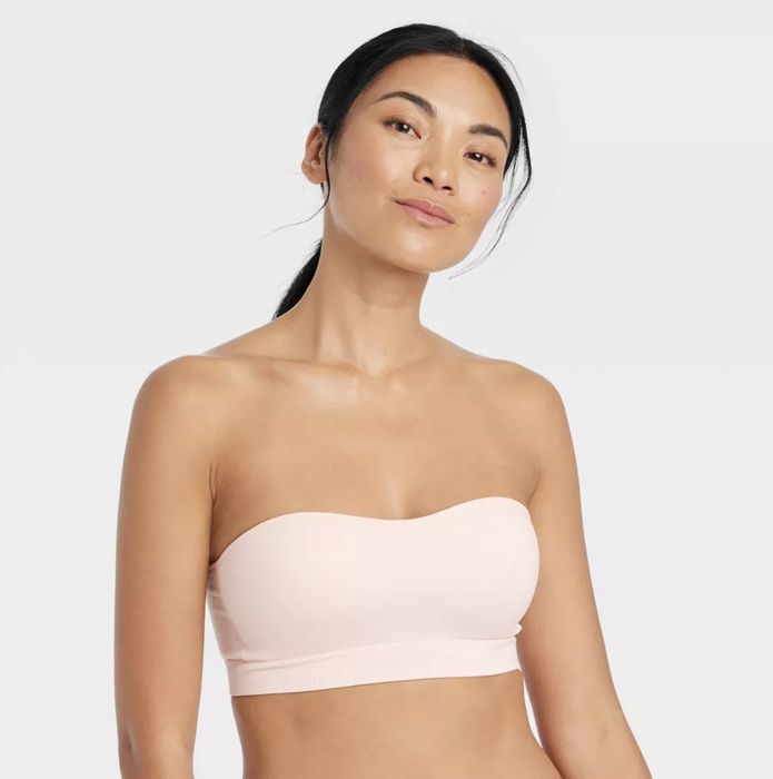 A model wearing a soft pink bandeau bra