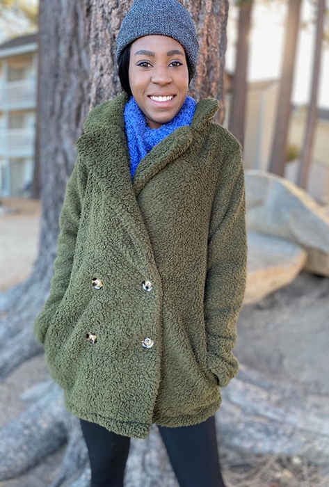 another reviewer wearing the green teddy coat buttoned up with a scarf