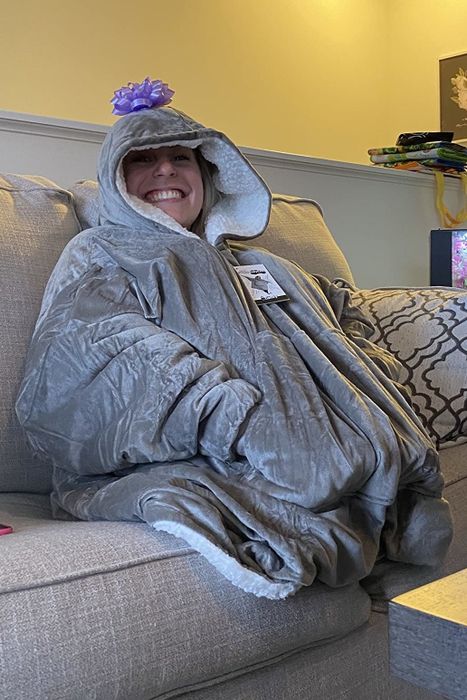 reviewer lounging on a couch in the gray sweatshirt