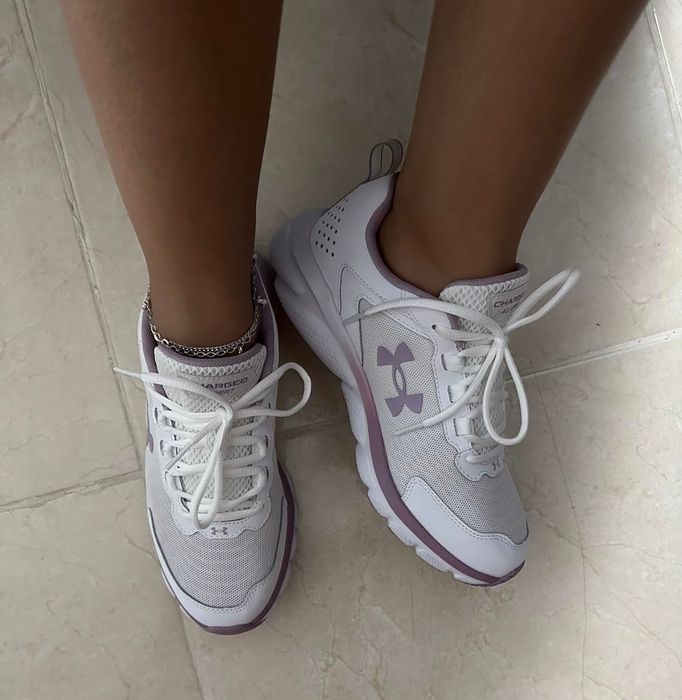 Reviewer wearing white and mauve lace-up sneakers.