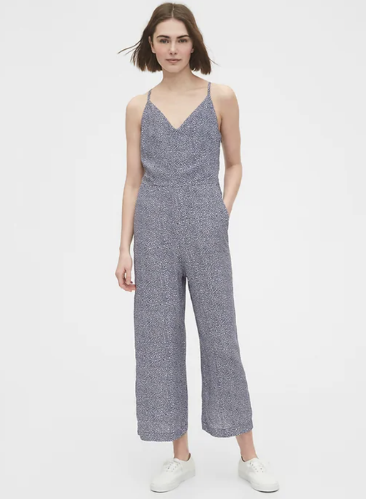 Model showcasing a blue floral tie-back jumpsuit