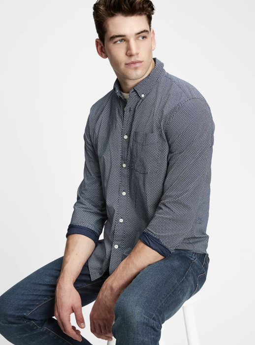 Model sporting a button-up shirt with navy geo print