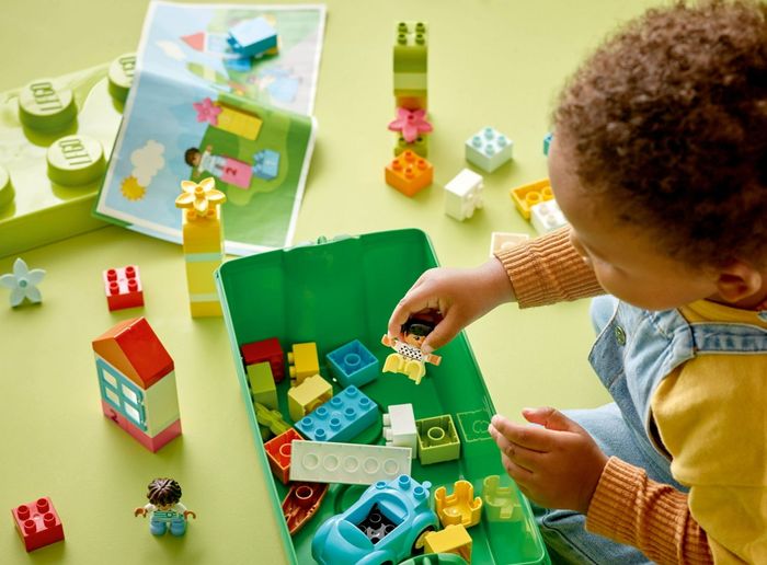 A child building with blocks on a table; text reads, 