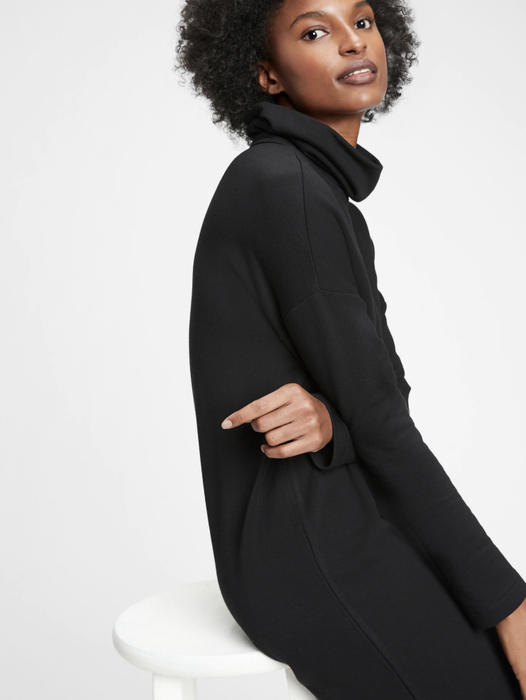 Model showcasing a classic black cowlneck dress