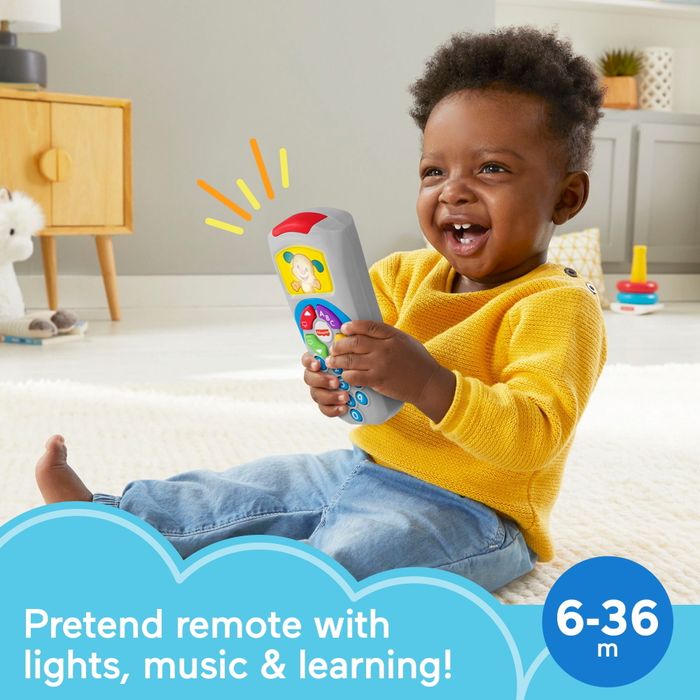 A child happily playing with a toy remote, lit up with colorful lights and sounds. The image displays the text: 