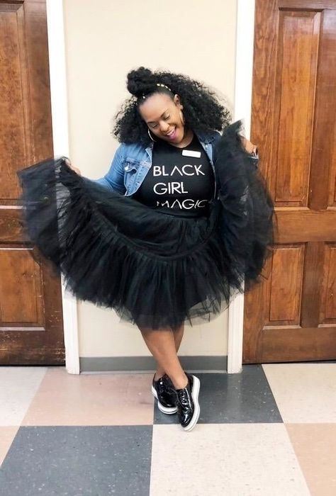 A reviewer is spotted wearing black patent platform brogues with white soles, paired with a denim jacket, a graphic tee, and a tulle skirt.