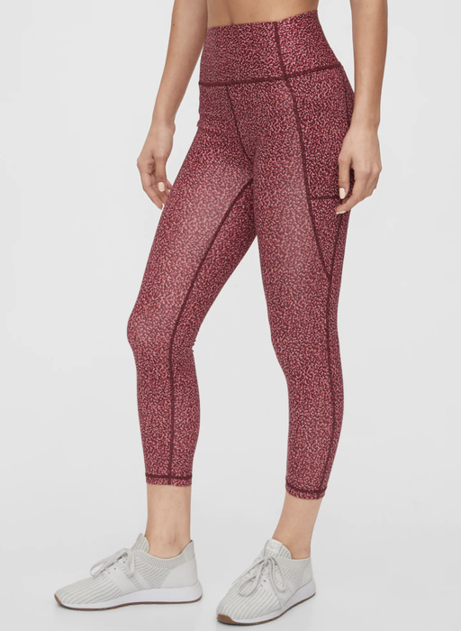 Model wearing high-rise leggings with a dotted red pattern