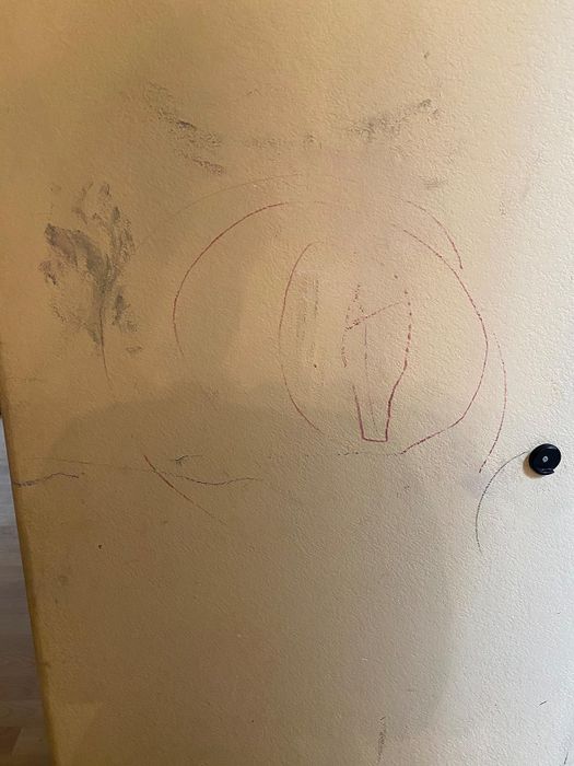 a wall covered in marker drawings