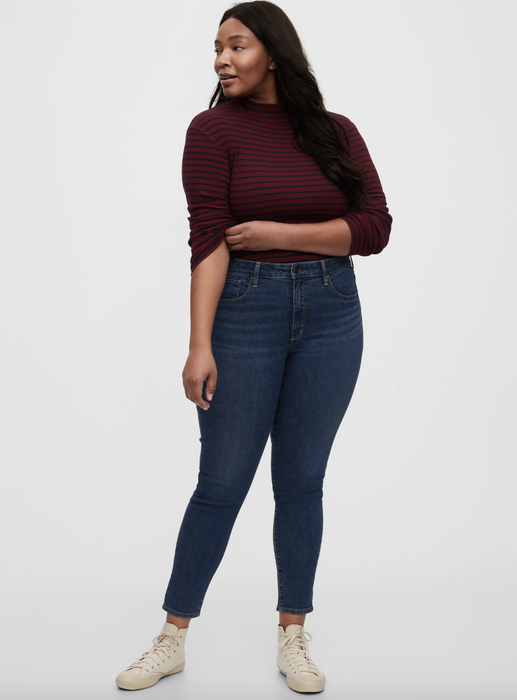 Model showcasing jeggings in a dark indigo shade