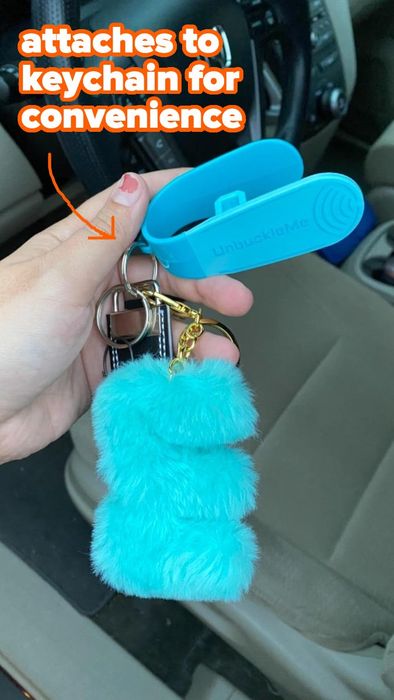 image of a hand holding a keychain featuring a blue fuzzy pom-pom and a blue UnbuckleMe tool, with text emphasizing its convenience