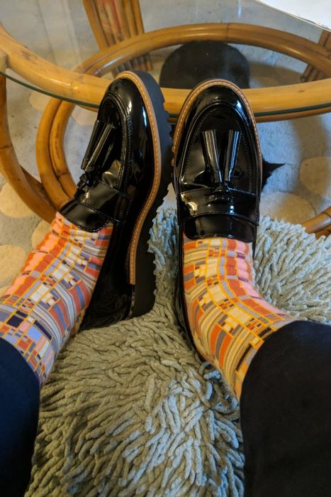 Reviewer pairing patterned socks with the black patent leather loafers.