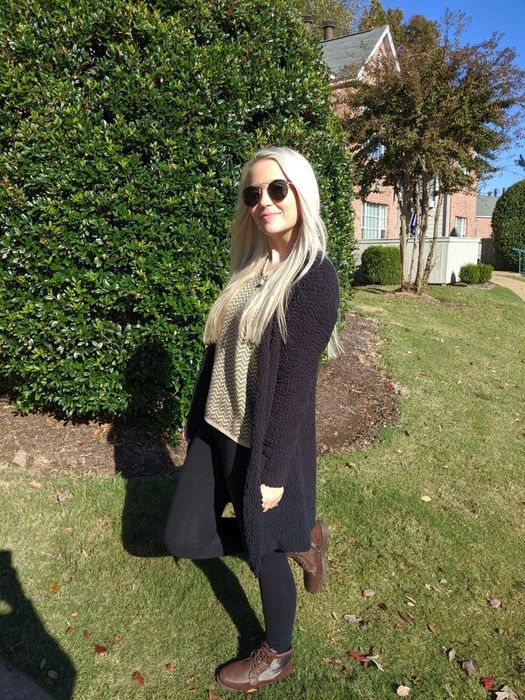 Reviewer showcasing a black cardigan