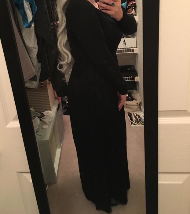 Reviewer modeling a long-sleeve black maxi dress