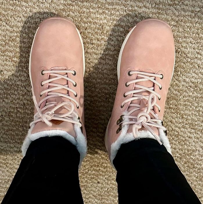 Reviewer showcasing the boots