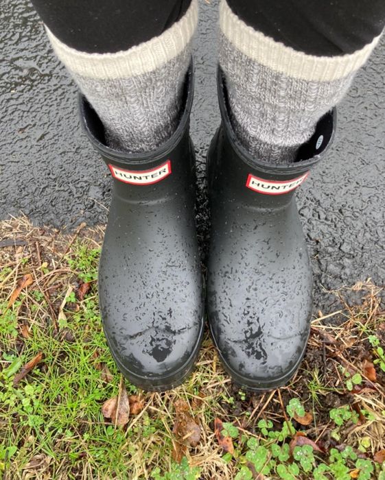 Reviewer wearing short black Hunter rain boots paired with socks.