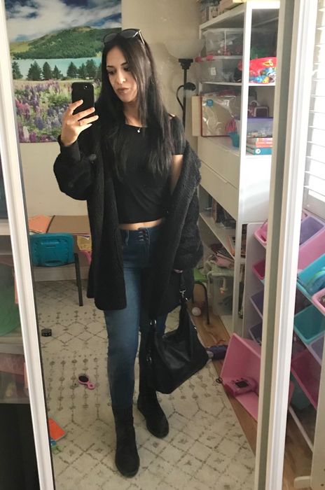 Reviewer styling a black sherpa hoodie