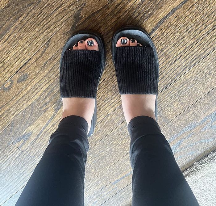 Image of a reviewer wearing the sandals in a timeless black shade.