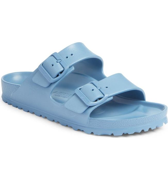 A pair of light blue Birkenstock sandals featuring adjustable straps