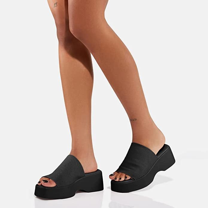 a model showcasing the sandals in black