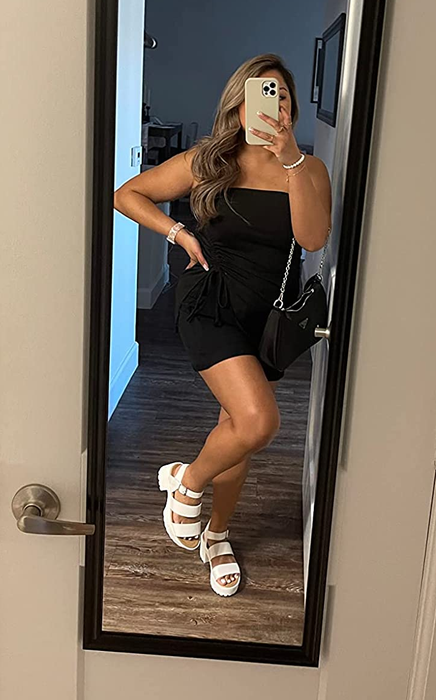 a reviewer showcasing the sandals in white