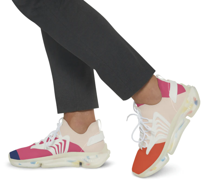 A model wearing stretchy sneakers in blue, pink, and light pink with laces across the top