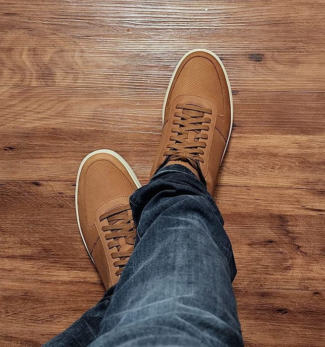 A reviewer showing off their brown sneakers.
