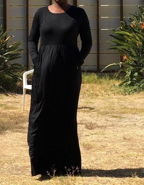 Reviewer wearing a long-sleeve black maxi dress