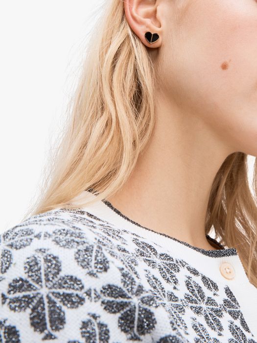 Model showcasing a black heart-shaped earring on her ear