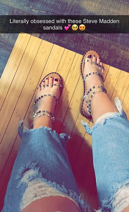 a reviewer wearing the sandals with a text overlay