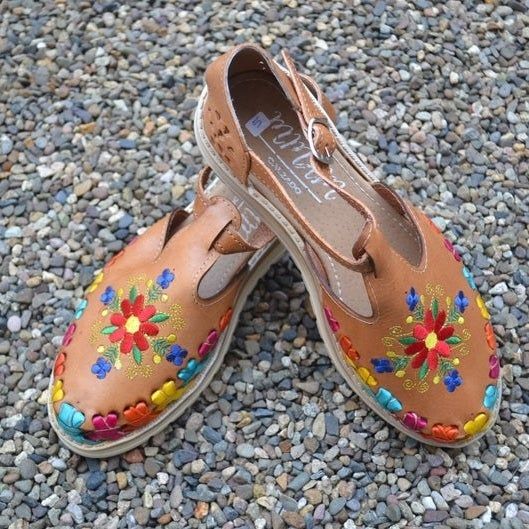 The sandals displayed to highlight their side design