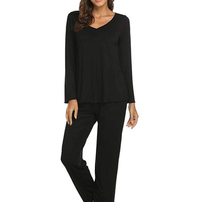 Model showcasing a black pajama top and pants