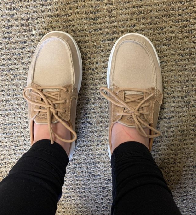 Image of a reviewer showing off the beige boat shoes.