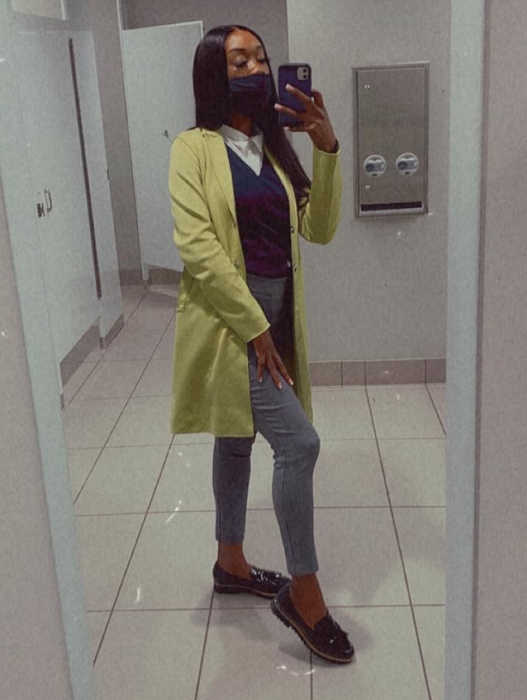 A reviewer posing in the loafers while taking a mirror selfie.