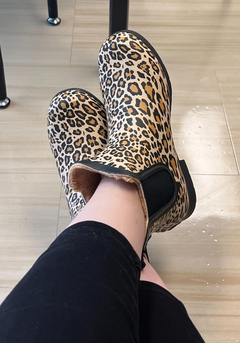 Reviewer wearing leopard print slip-on boots.