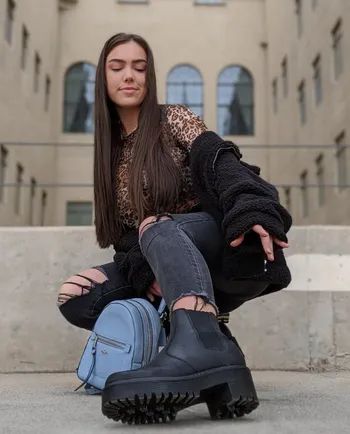 Reviewer sporting black loafers with brown embroidered designs and fur-trimmed heels