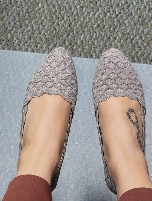 Reviewer wearing taupe woven flats with a pointed toe