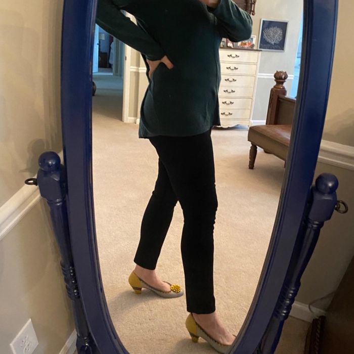 Reviewer styling black jeans with heels and a long top