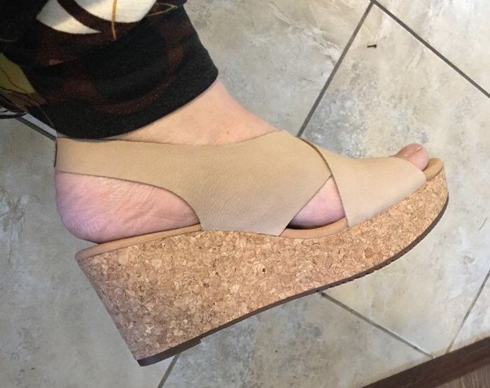 Reviewer photo featuring the beige wedge sandals.