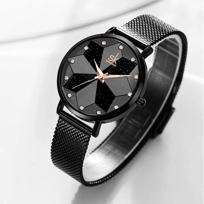 Front view of a black watch featuring a starry background