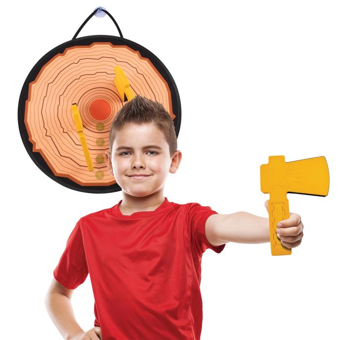 A boy holds a foam axe in front of a target, ready to toss it.