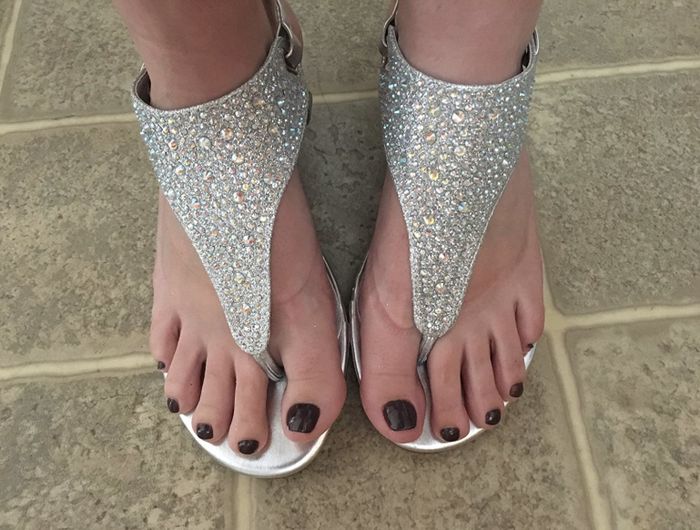 A reviewer’s photo showing her wearing silver wedge sandals