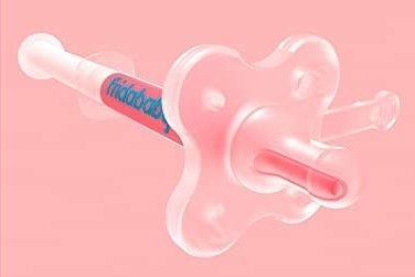 A close-up view of the pacifier-style medicine dispenser